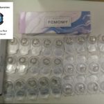 packages of contact lenses laid out on a table with CBP Cincinnati seal