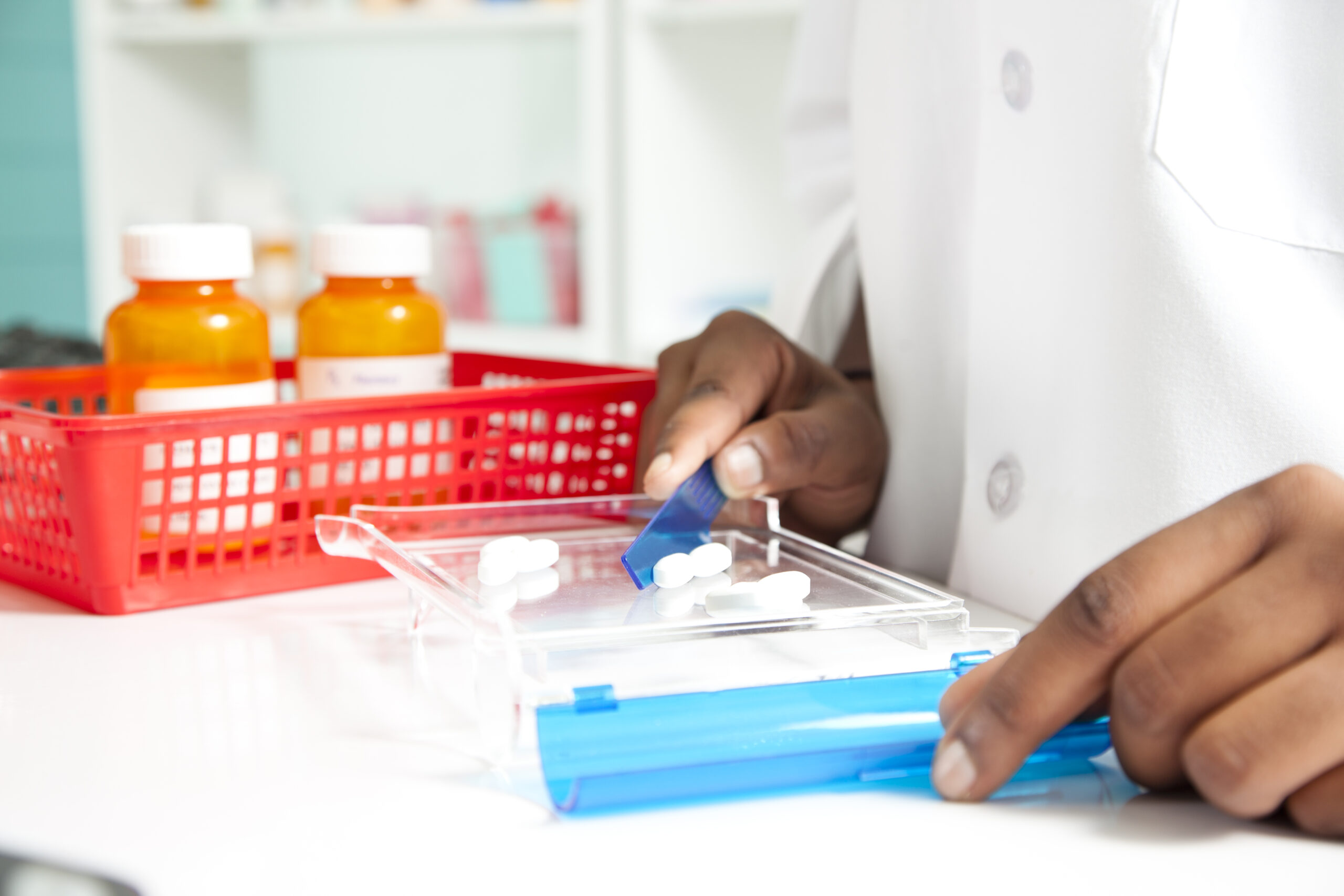 Pharmacist counting pills for a prescription